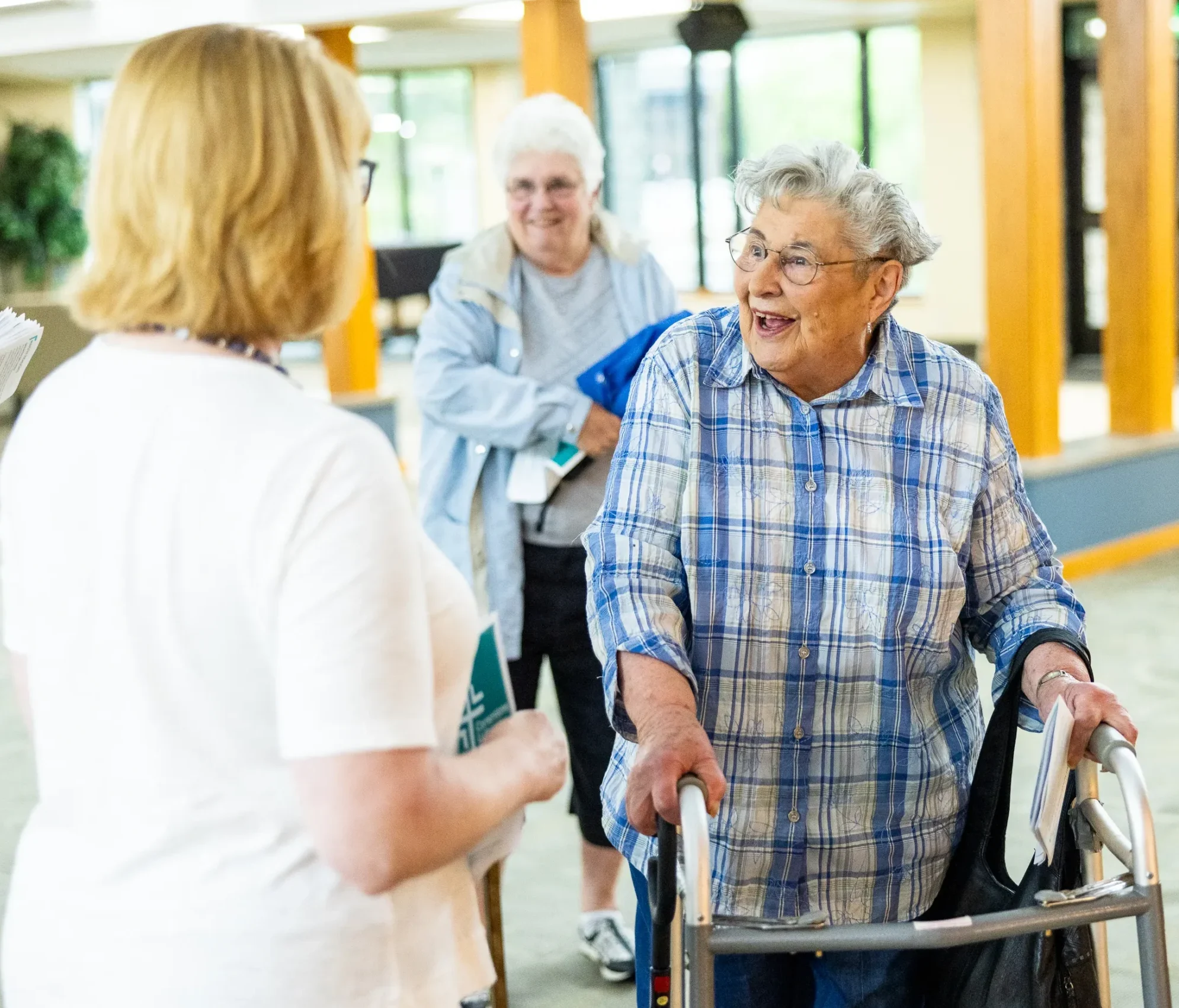 An elderly woman with a walker greeting a church member at Cornerstone Lutheran Church in Carmel.